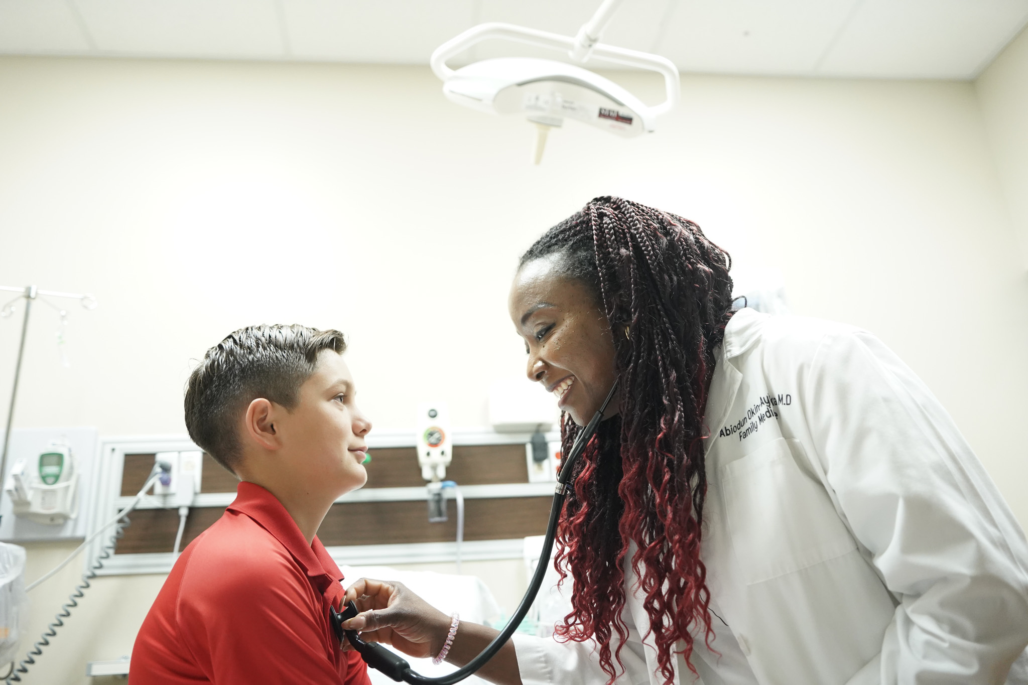 Image of young male patient undergoing treatment and speaking with a provider