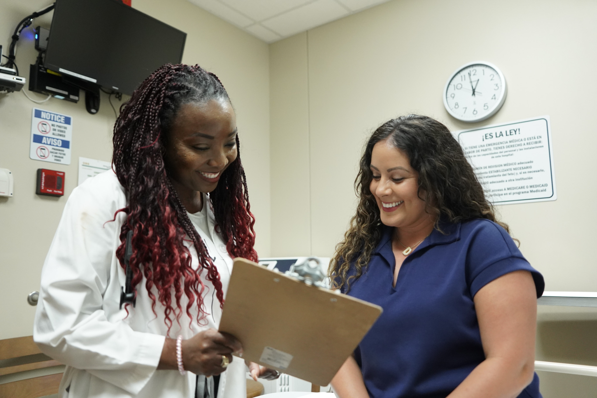 Image of young mom undergoing treatment and speaking with a provider